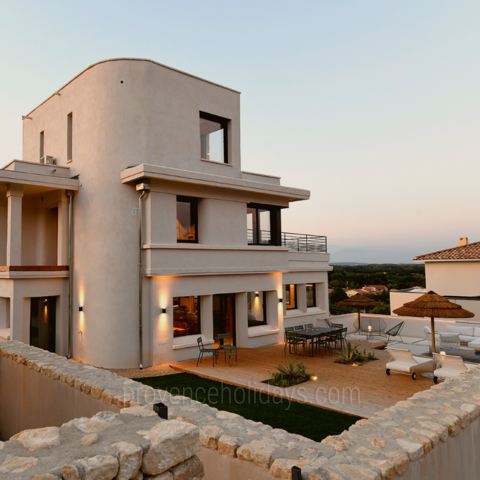 The modern aesthetic of this Greek-style holiday rental contrasts beautifully with the authentic Provencal landscape.